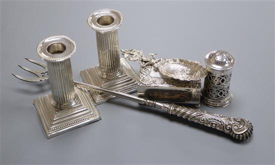 A pair of Edwardian silver dwarf candlesticks, Sheffield, 1903, silver pepperette, Dutch silver spoon, toasting fork and match sleeve